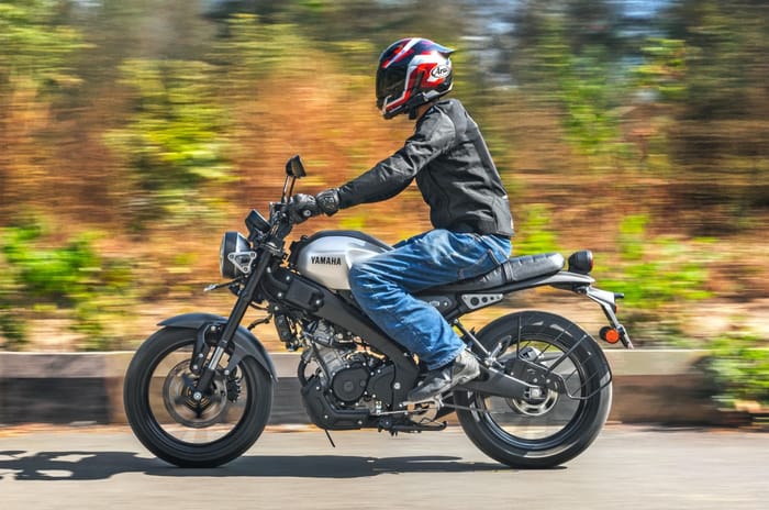 Yamaha XSR155 left side profile riding shot on road